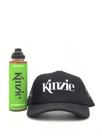 Kinzie brand bottle of BBQ sauce and black cap on a white background