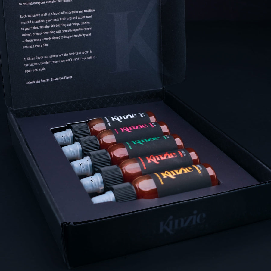 5 pack mini BBQ gift set featuring five 1 oz bottles of sauces in a black box with Kinzie branding.