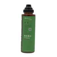 Bottle with green label and black cap on a white background