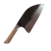 Hand forged butcher knife with a curved blade, textured surface, and wooden handle.